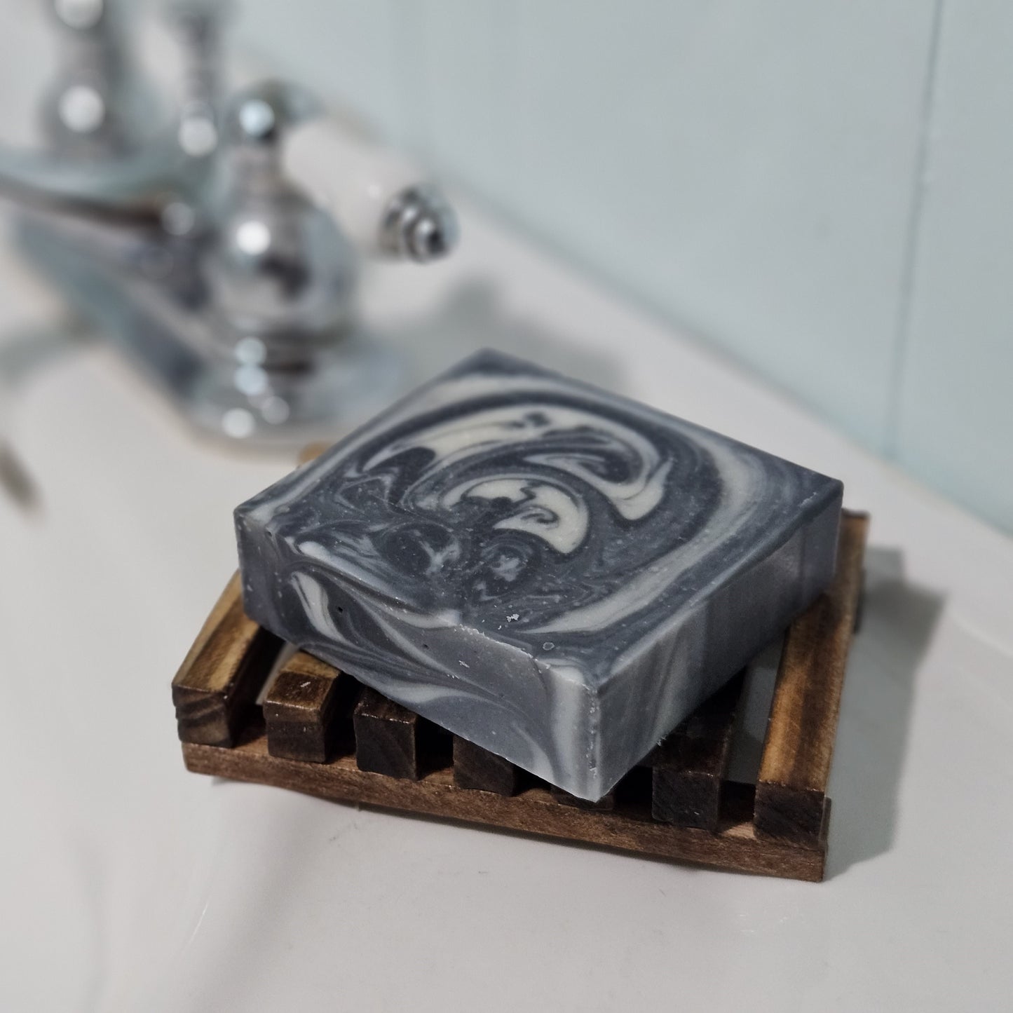 Charcoal Cleanse soap bar on soap saver dish beside sink