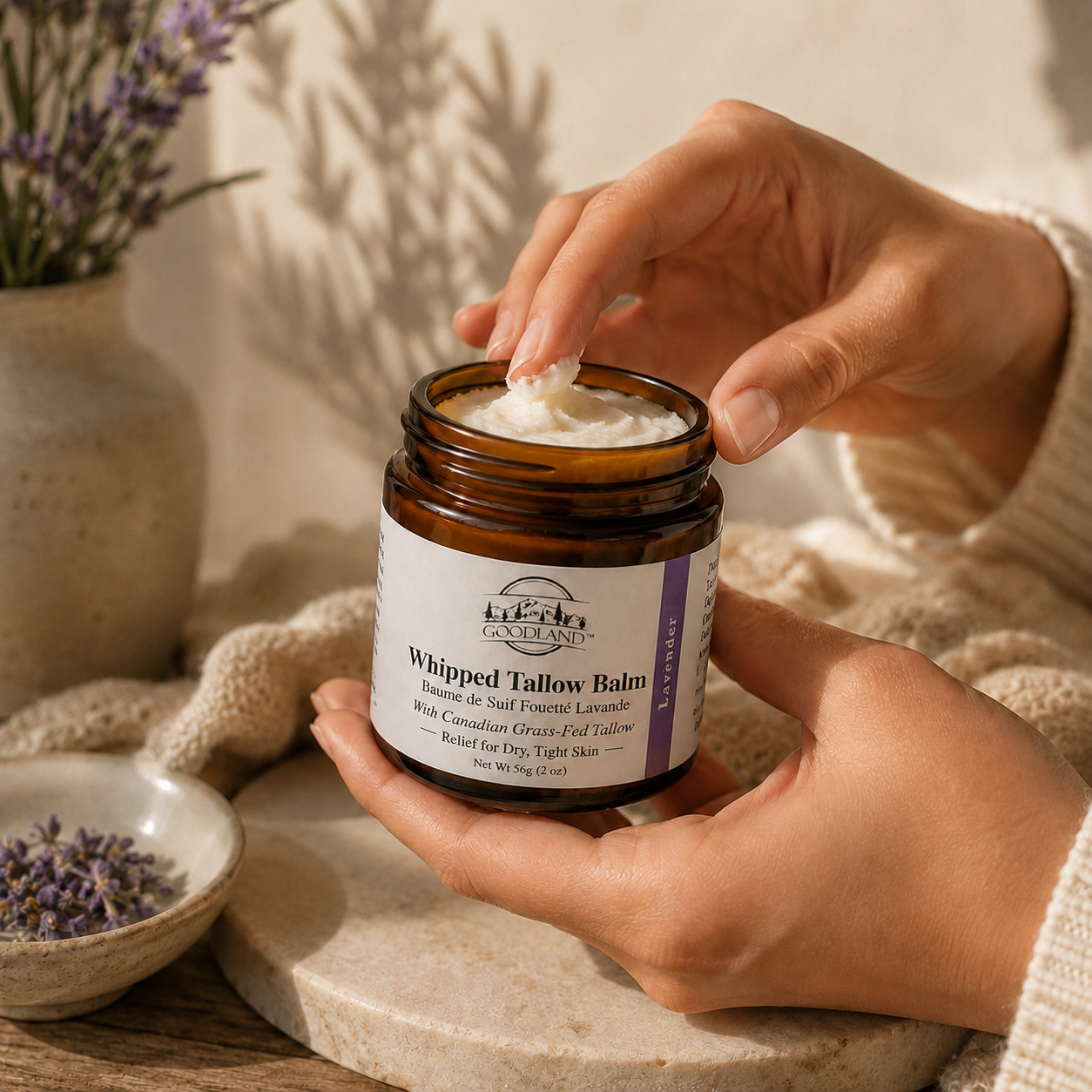 Person applying Goodland whipped tallow balm from jar