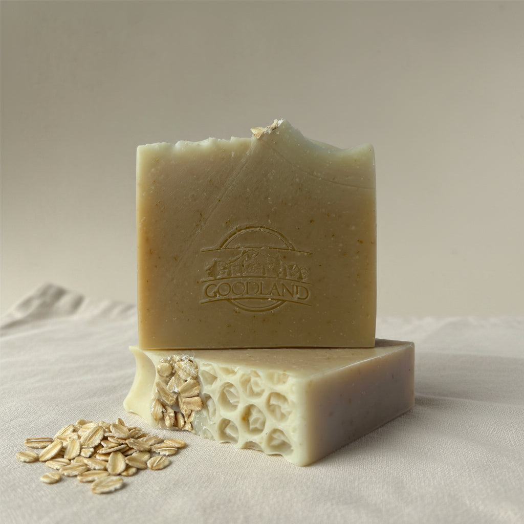 Two bars of soap with Goodland brand logo on linen
